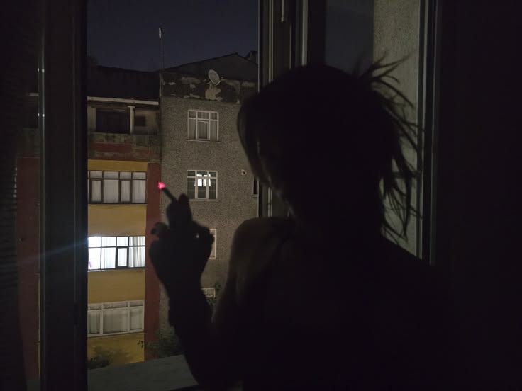 Silhouette at a window at night